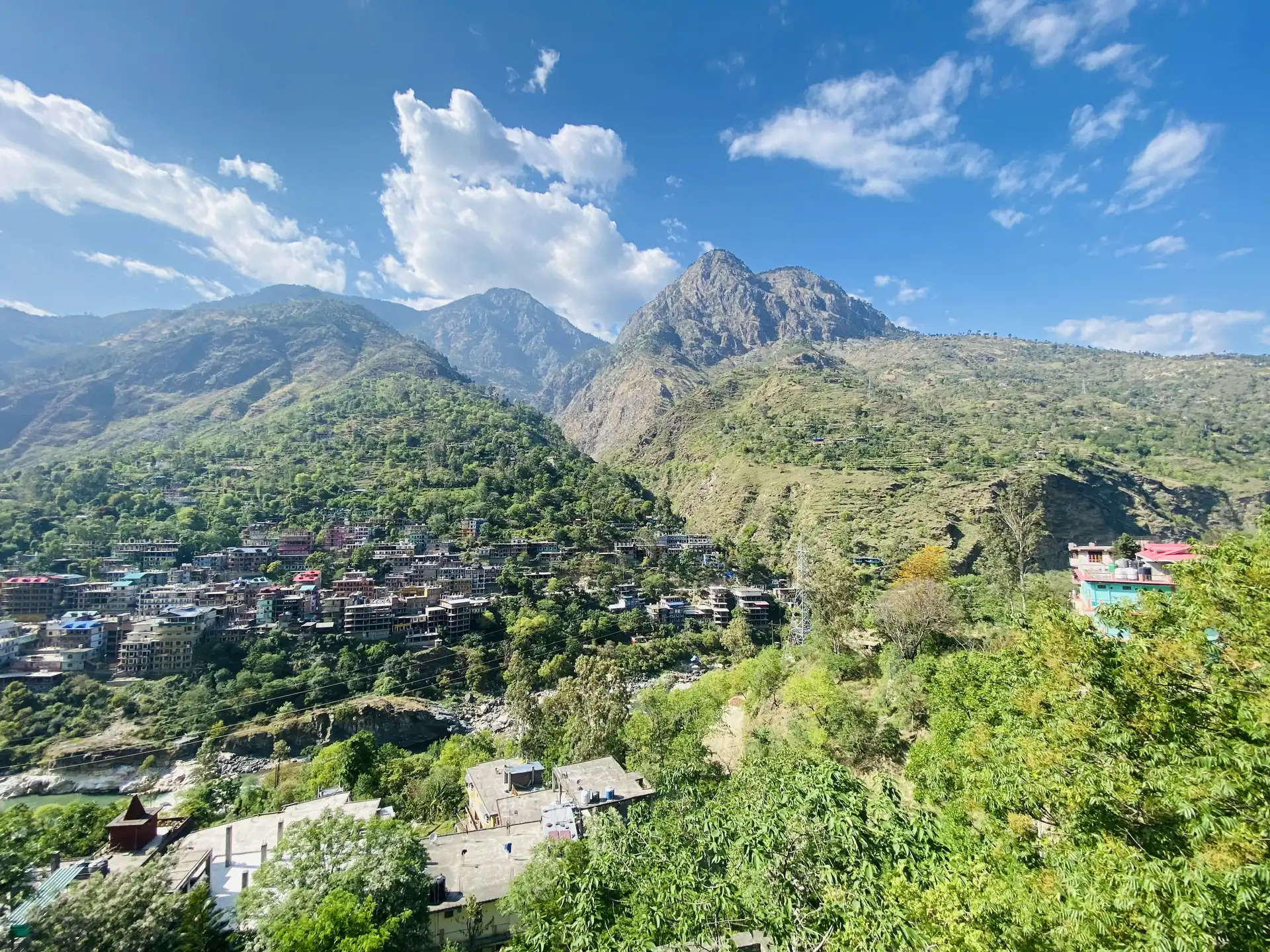 The houses of Rampur Bushahr on the slope above the Satluj with mountains behind under a blue sky