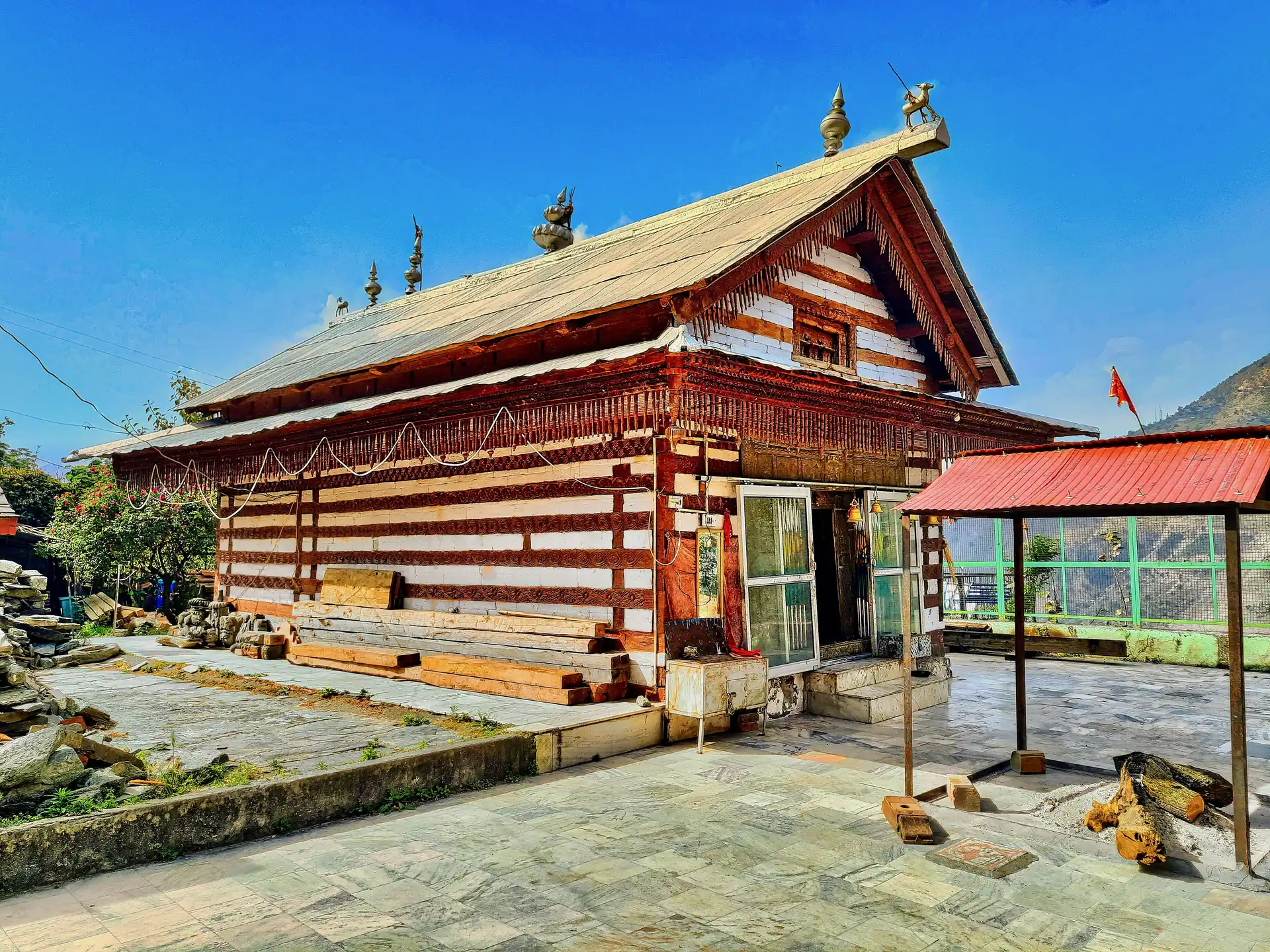 The Ambika Devi temple at Nirmand, a wooden temple with a slate roof and walls of alternating stone and timber