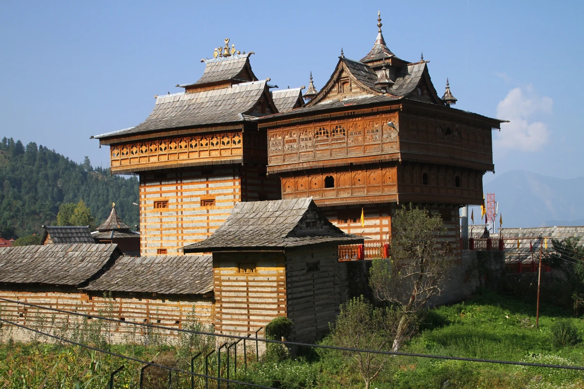 The twin towers of the Bhimakali Temple at Sarahan, with carved timber upper storeys and slate roofs under a blue sky