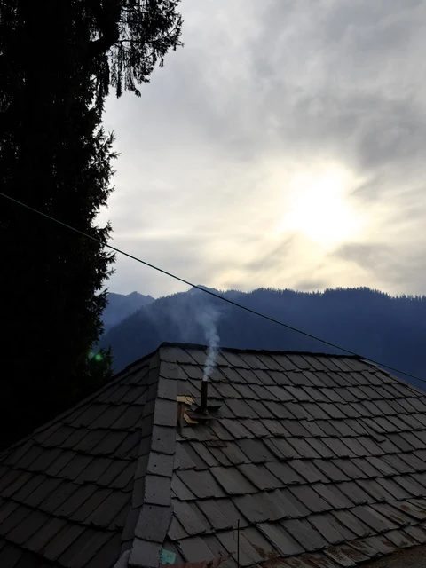 A slate roof at Shoja against the evening ridge