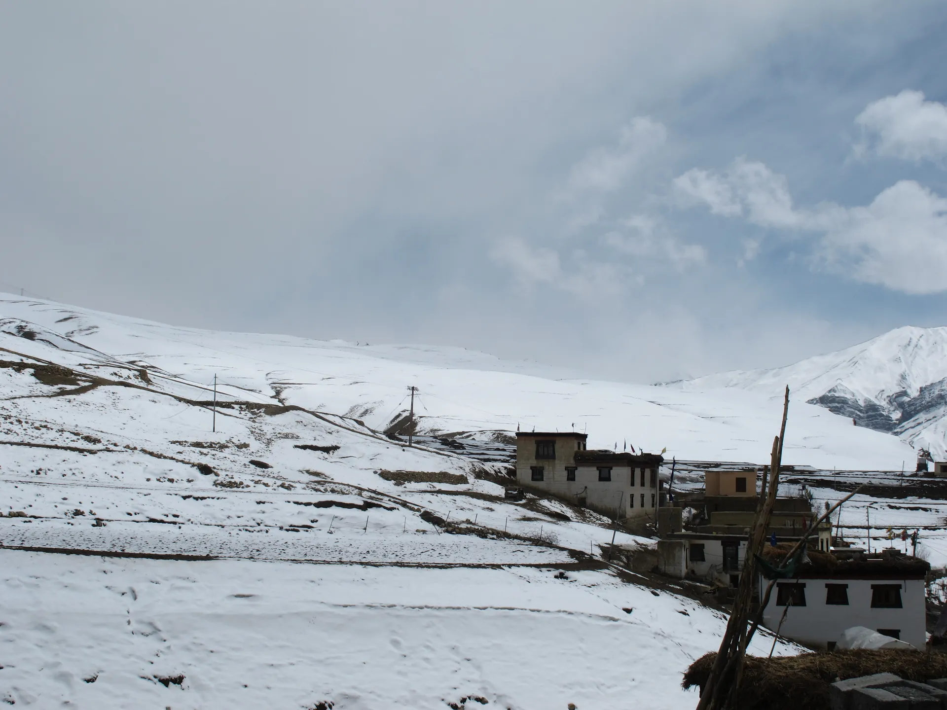 Kibber's flat-roofed houses on a snow-covered slope in Spiti