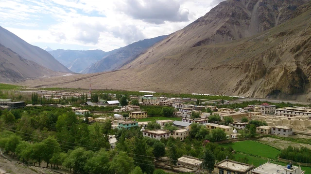 Tabo village in the Spiti valley seen from above, with the monastery buildings on the right and bare mountains behind